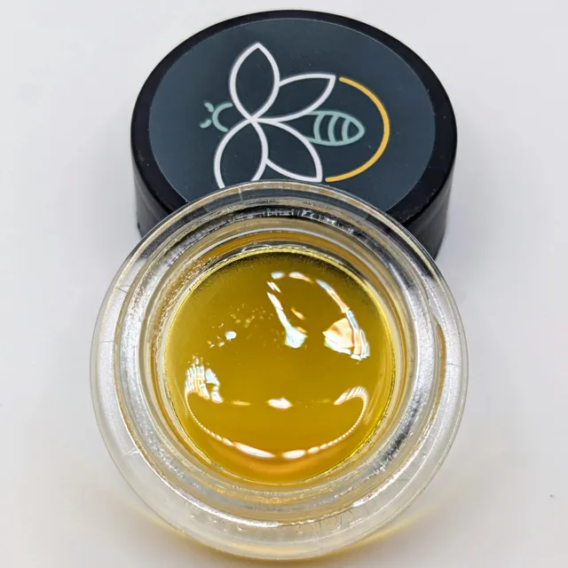 Golden Lemon Drip Fire Bug sauce beside its branded jar lid
